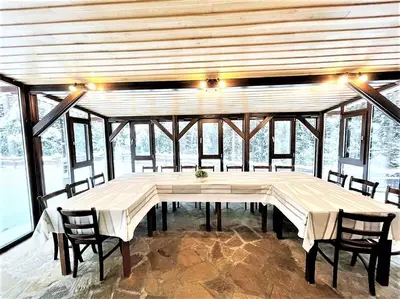 a large dining room with a table and chairs at Комплекс Орлово гнездо in Beli Iskar
