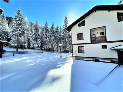 a snow covered yard in front of a house at Комплекс Орлово гнездо in Beli Iskar