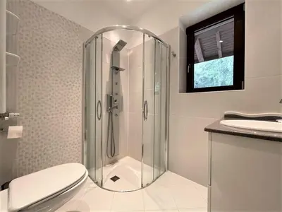 a bathroom with a shower and a toilet and a sink at Комплекс Орлово гнездо in Beli Iskar