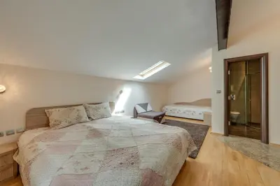 a bedroom with a bed and a chair in it at Комплекс Орлово гнездо in Beli Iskar