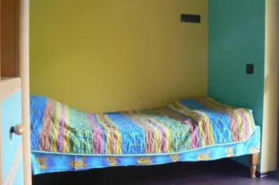 a bed with a colorful comforter in a bedroom at Nordic Villa Chiflika in Chiflik