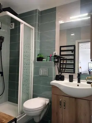 a bathroom with a sink and a toilet and a shower at Pearl XL in Pamporovo