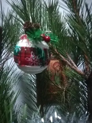 a red and white ornament on a christmas tree at Къща Христини in Kalofer