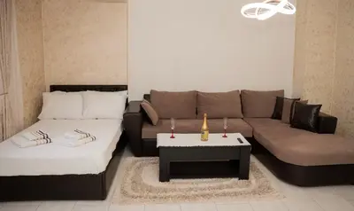 a living room with a couch and a coffee table at Къща за гости Шарон in Petrich