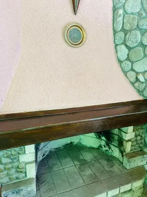 a wooden bench sitting in front of a wall at Къща за гости Станеви in Ribarica
