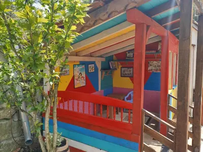 a colorful play house with a tree at Къща за гости Вишнева градина in Brestnik