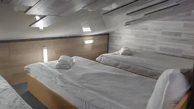 a room with two beds in a room at Къща за гости Вишнева градина in Brestnik