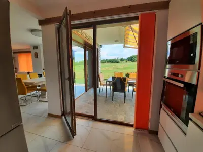a living room with a door leading to a dining room at Mountain Villa near Bansko in Razlog