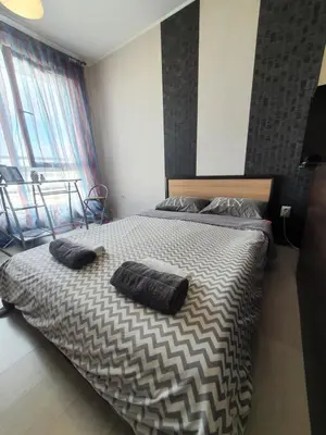 a bedroom with a bed with two pillows on it at Nights apartment in Sofia