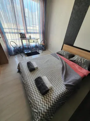 a bedroom with a bed with two pillows on it at Nights apartment in Sofia