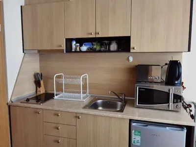 a kitchen with a sink and a microwave at Студио за трима, басейн, Aspen Golf Resort, Банско, Разлог in Razlog