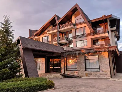 a large building with a lot of windows at Студио за трима, басейн, Aspen Golf Resort, Банско, Разлог in Razlog