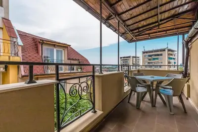 a balcony with a table and chairs at 1BD Flat with a lovely terrace in the centre of Plovdiv by Flat Mаnager in Plovdiv