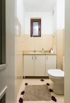 a bathroom with a toilet and a sink and a mirror at 1BD Flat with a lovely terrace in the centre of Plovdiv by Flat Mаnager in Plovdiv