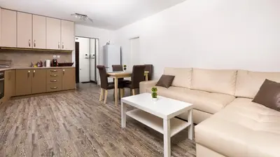 a living room with a couch and a table and a kitchen at 1BD Flat with a lovely terrace in the centre of Plovdiv by Flat Mаnager in Plovdiv