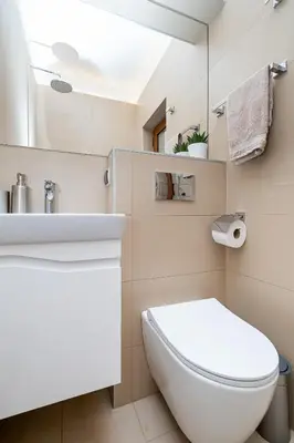 a bathroom with a white toilet and a sink at Bohemia - New Apartment with Stylish Design in Sofia