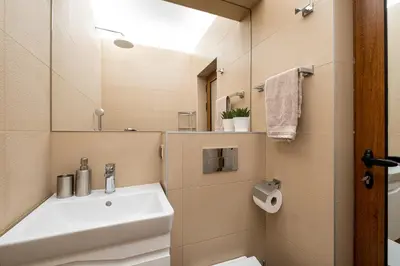 a bathroom with a sink and a mirror at Bohemia - New Apartment with Stylish Design in Sofia