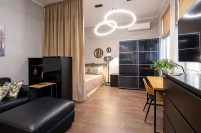 a living room with a couch and a bed at Bohemia - New Apartment with Stylish Design in Sofia