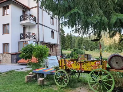 a yellow carriage parked in front of a building at Апартамент Лейк Вю, вила Флора, комплекс Маунтин лейк in Smolyan
