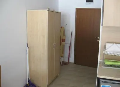a kitchen with a wooden cabinet next to a door at Aspen Heights 4 bed studio in Bansko