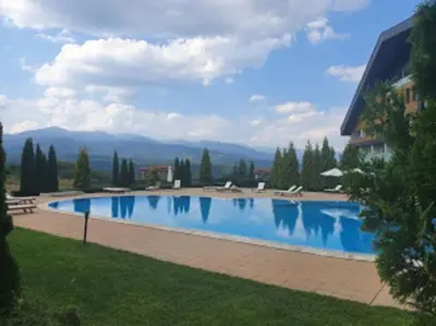 a large swimming pool in the middle of a yard at Aspen Heights 4 bed studio in Bansko
