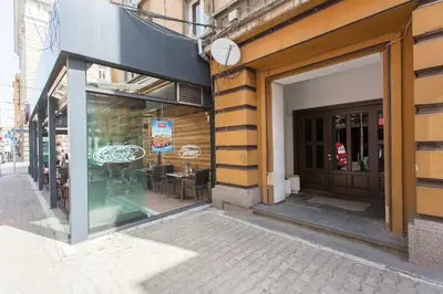 a store front with glass doors on a street at Sunny and Modern 1BDR Apartment in the Center in Sofia