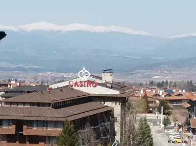 a building with a casino sign on the top of it at Старият Хан-Б24 in Bansko