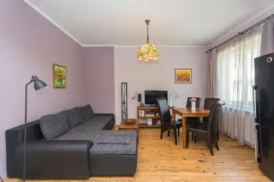 a living room with a couch and a table at Colorful 2BDR Apartment in the City Center in Sofia