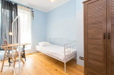 a bedroom with a bed and a desk and a table at Colorful 2BDR Apartment in the City Center in Sofia
