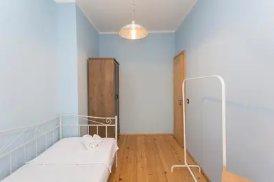 a small room with a bed and a locker at Colorful 2BDR Apartment in the City Center in Sofia