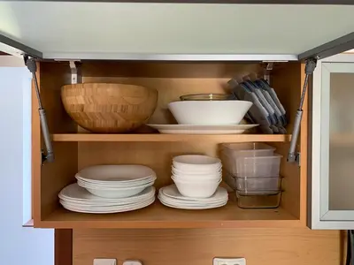 a cabinet filled with plates and bowls and dishes at Todorka Apartments in Bansko in Bansko