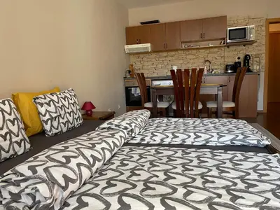 a living room with a couch and a kitchen at Bansko SPA Studio at Predela1 in Bansko
