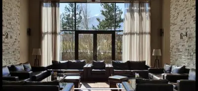 a large living room with couches and a large window at Luxury Apartment Pirin Chalet in Terra Complex in Bansko