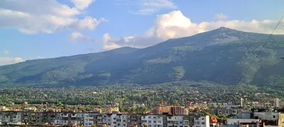 a view of a city with a mountain in the background at Panoramic and Spacious Flat near the City Centre in Sofia