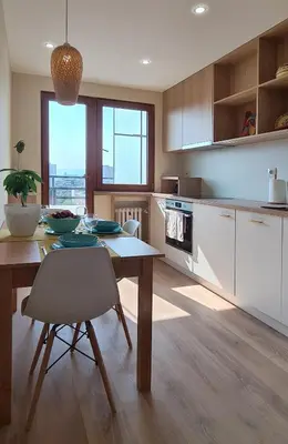 a kitchen with a table and a dining room at Panoramic and Spacious Flat near the City Centre in Sofia