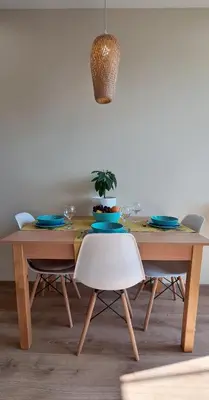 a dining room table with a white chair at Panoramic and Spacious Flat near the City Centre in Sofia