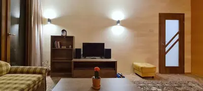 a living room with a couch and a tv at Panoramic and Spacious Flat near the City Centre in Sofia