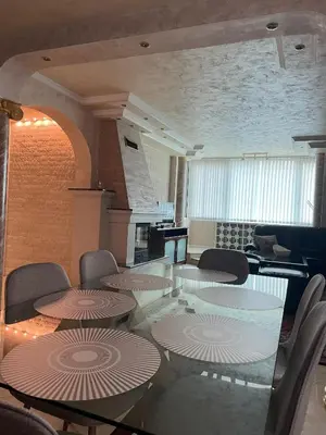 a conference room with tables and chairs and a fireplace at Apart 47 in Smolyan