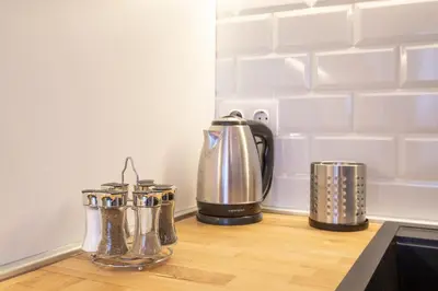 a kitchen counter with utensils on a counter top at Designer & Cozy 2BD Flat with a parking in the city center by Flat Mаnager in Sofia