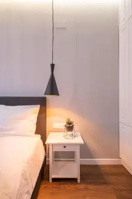 a bedroom with a white bed and a white table at Designer & Cozy 2BD Flat with a parking in the city center by Flat Mаnager in Sofia