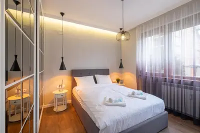 a bedroom with a bed with two towels on it at Designer & Cozy 2BD Flat with a parking in the city center by Flat Mаnager in Sofia