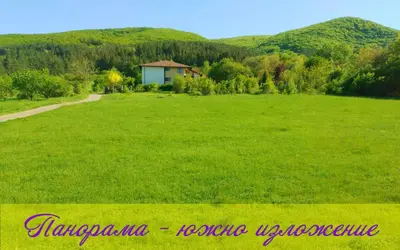 a large green field with a house in the distance at Стаи за Гости Lavender Lozen in Lozen