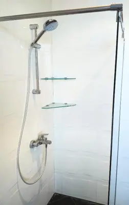 a shower in a bathroom with a shower head at Стаи за Гости Lavender Lozen in Lozen