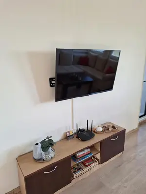 a living room with a television on a wall at The View in Sandanski