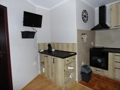 a kitchen with a counter and a tv on the wall at Deer's Home at Elit Pamporovo in Pamporovo