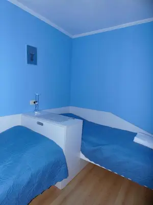 a room with two beds and a blue light at Deer's Home at Elit Pamporovo in Pamporovo