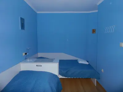 a blue room with a bed and a sink at Deer's Home at Elit Pamporovo in Pamporovo