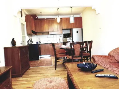a kitchen and living room with a couch and a table at Jasmine appart Metro station, 2BDR, FREE Parking in Sofia