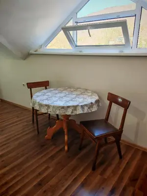 a table and two chairs in a room with a window at Дом Бакалски-Кмета in Narechenski Bani
