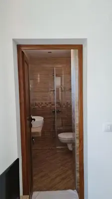 a bathroom with a sink and a tub and a toilet at Hotel Geppy in Sofia